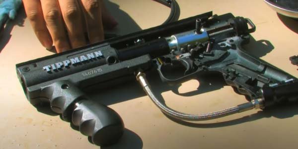 Dismantle the paintball gun using the right tools